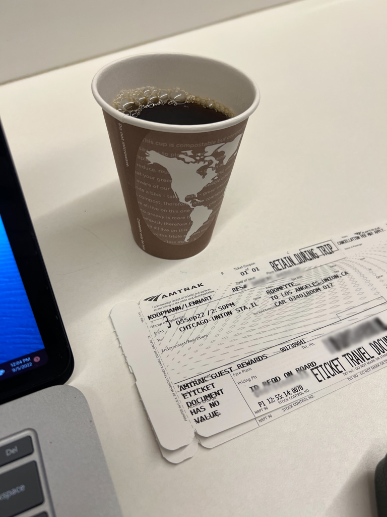Coffee and boarding pass at the Chicago Union Station Amtrak lounge